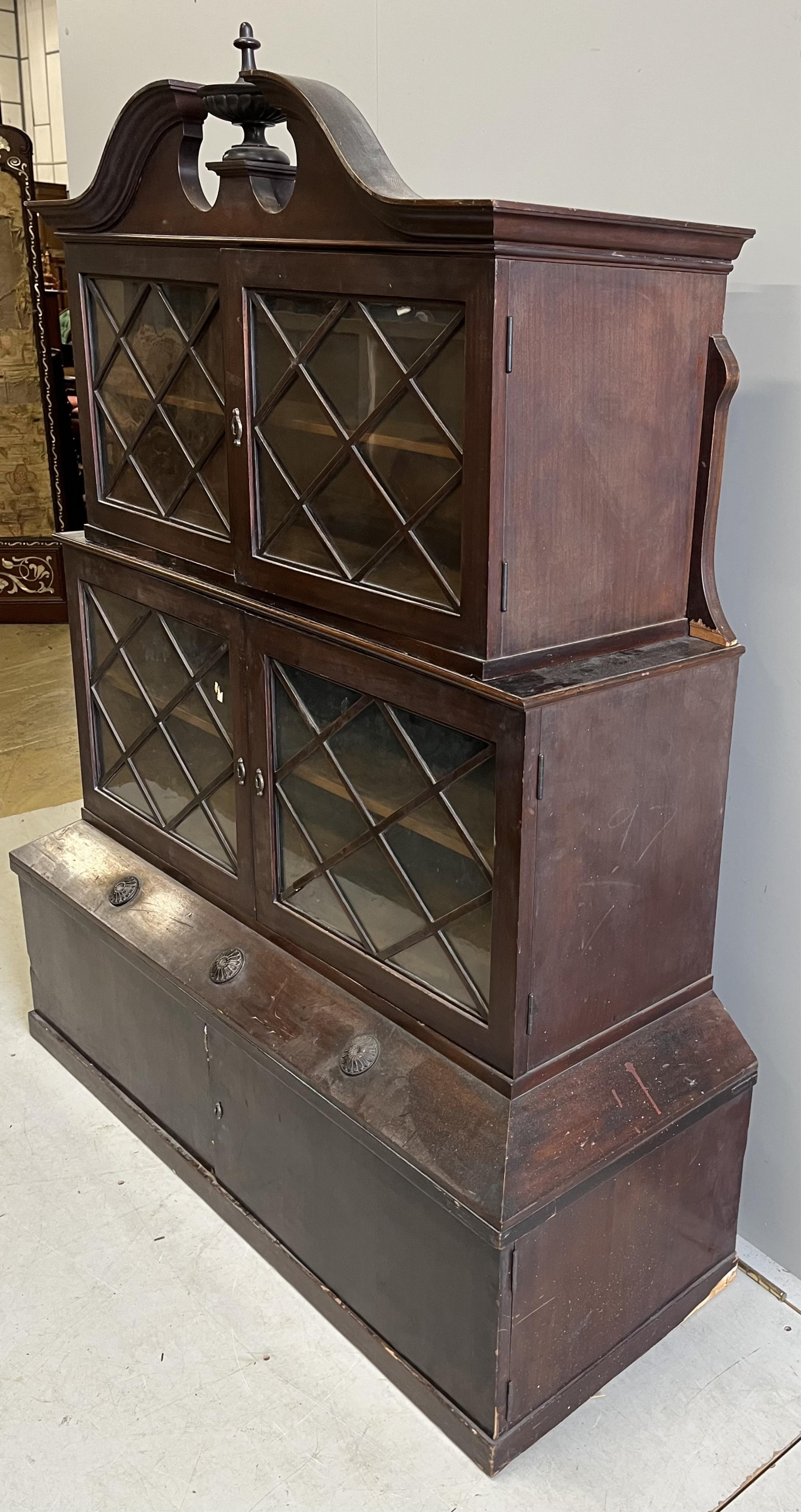 A George III style mahogany three section bookcase / cabinet, incorporating old timber, width 126cm, depth 47cm, height 160cm